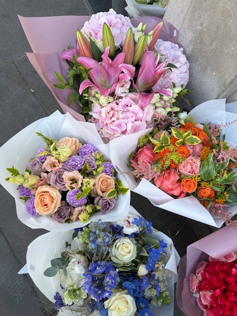 A selection of four floral bouquets arranged for flower delivery, featuring a variety of fresh flowers. The top bouquet showcases pink lilies with large, closed buds and pink hydrangeas, wrapped in pi
